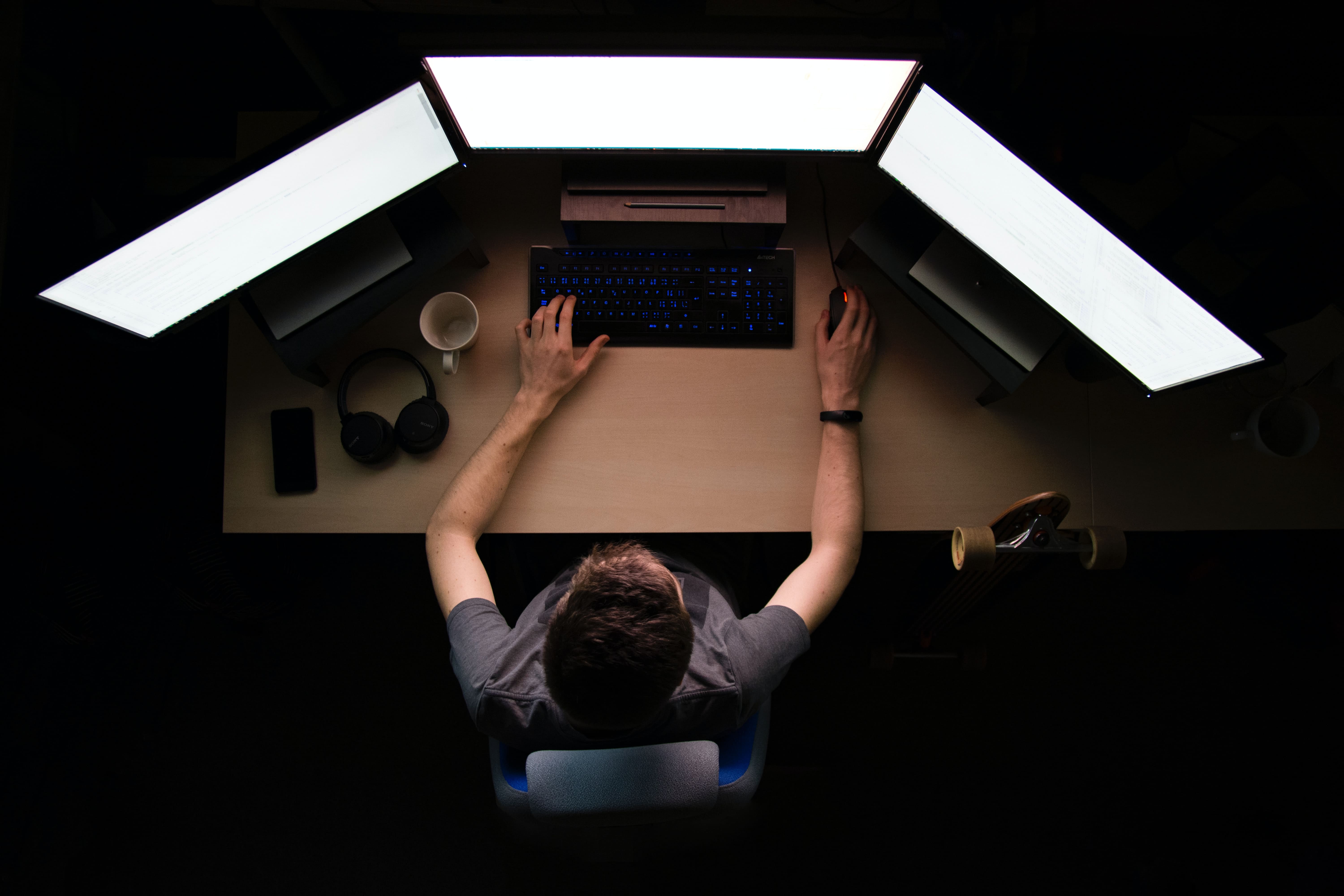 a programmer desk with some monitors